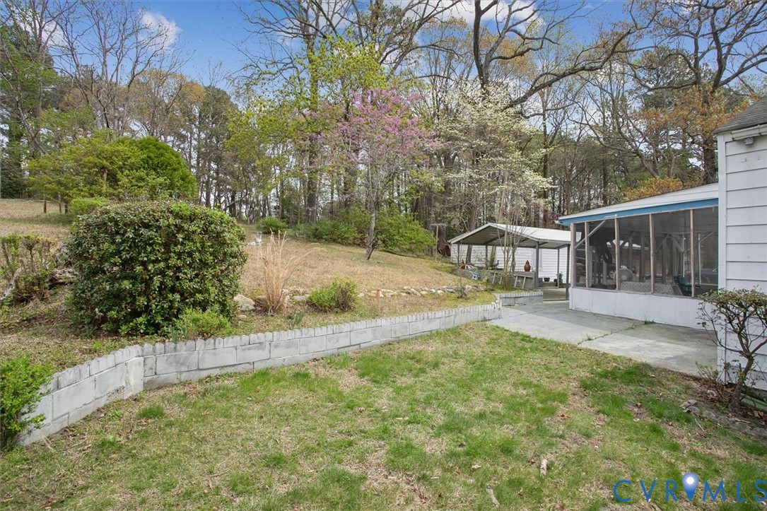 6266 Richmond Road Williamsburg, VA 23188 - Photo 23 of 27 a view of a house with backyard and sitting area
