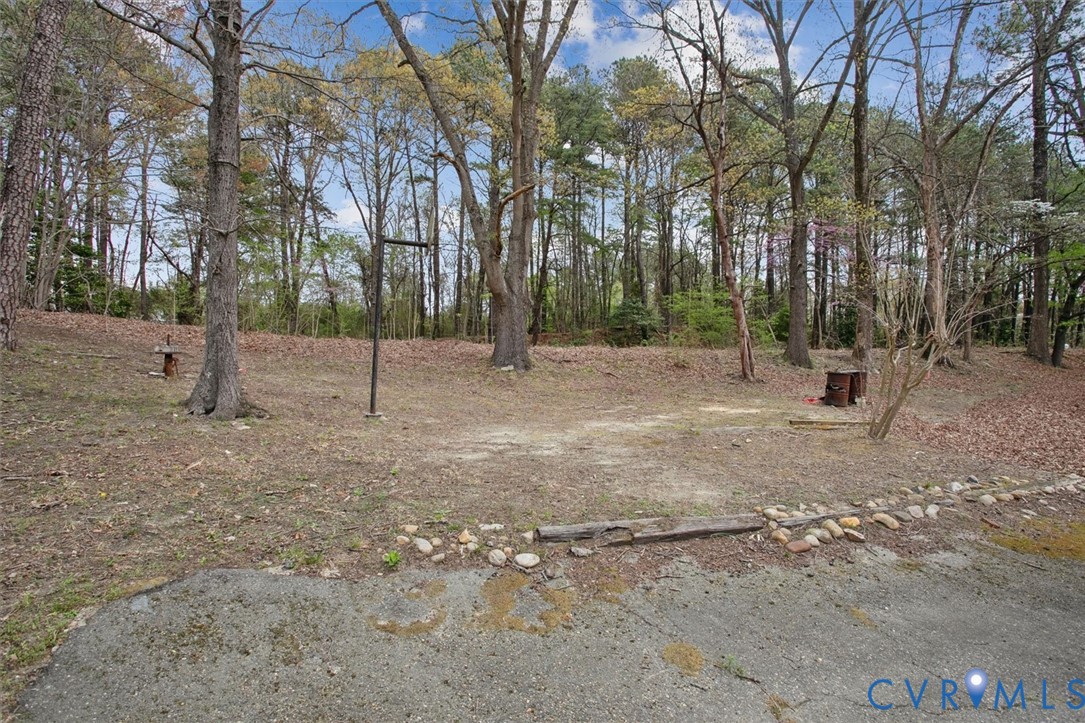 6266 Richmond Road Williamsburg, VA 23188 - Photo 25 of 27 a view of empty field with trees in the background