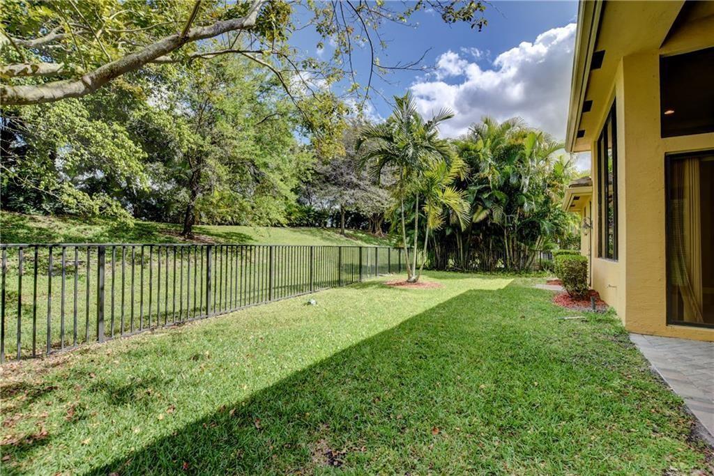 10295 Trianon Place Wellington, FL 33449 - Photo 16 of 26 a view of a backyard with a small garden