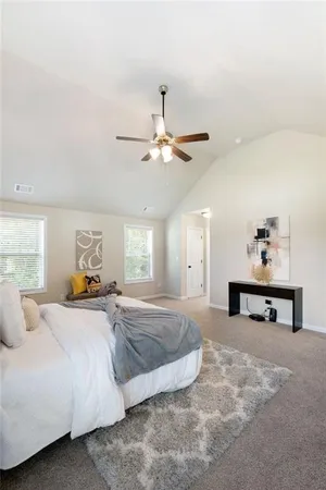 a bedroom with a large bed and a window