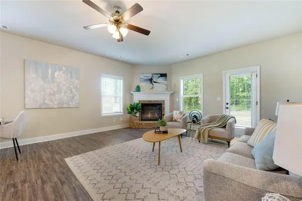 a living room with furniture and kitchen view