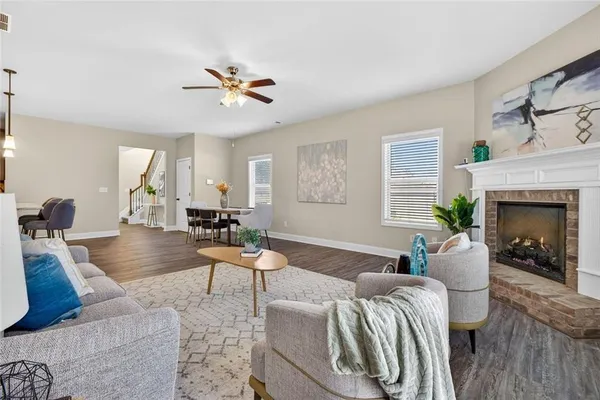 a kitchen with stainless steel appliances granite countertop a sink a stove and a wooden floors