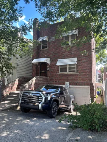 a front view of a house with parking space