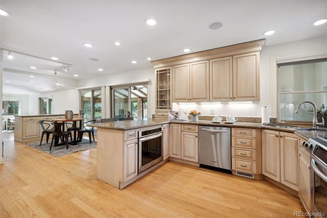 a kitchen with stainless steel appliances granite countertop a stove and a sink