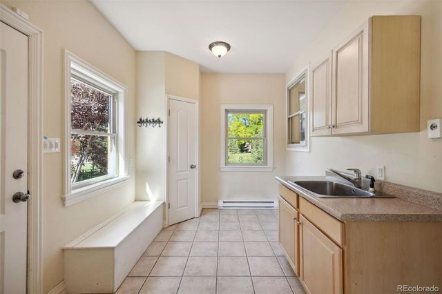 a kitchen with a sink cabinets and window
