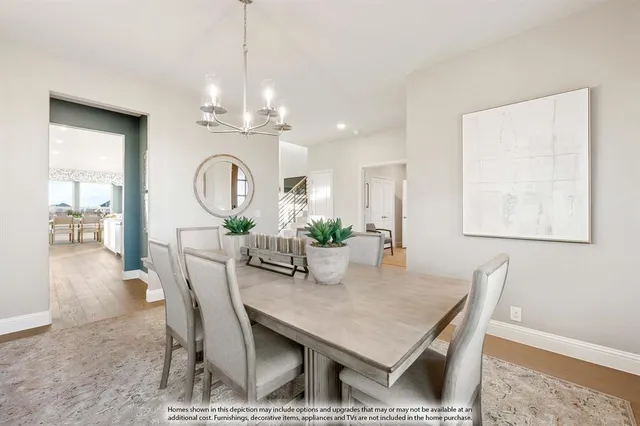 a view of a dining room with furniture and a chandelier