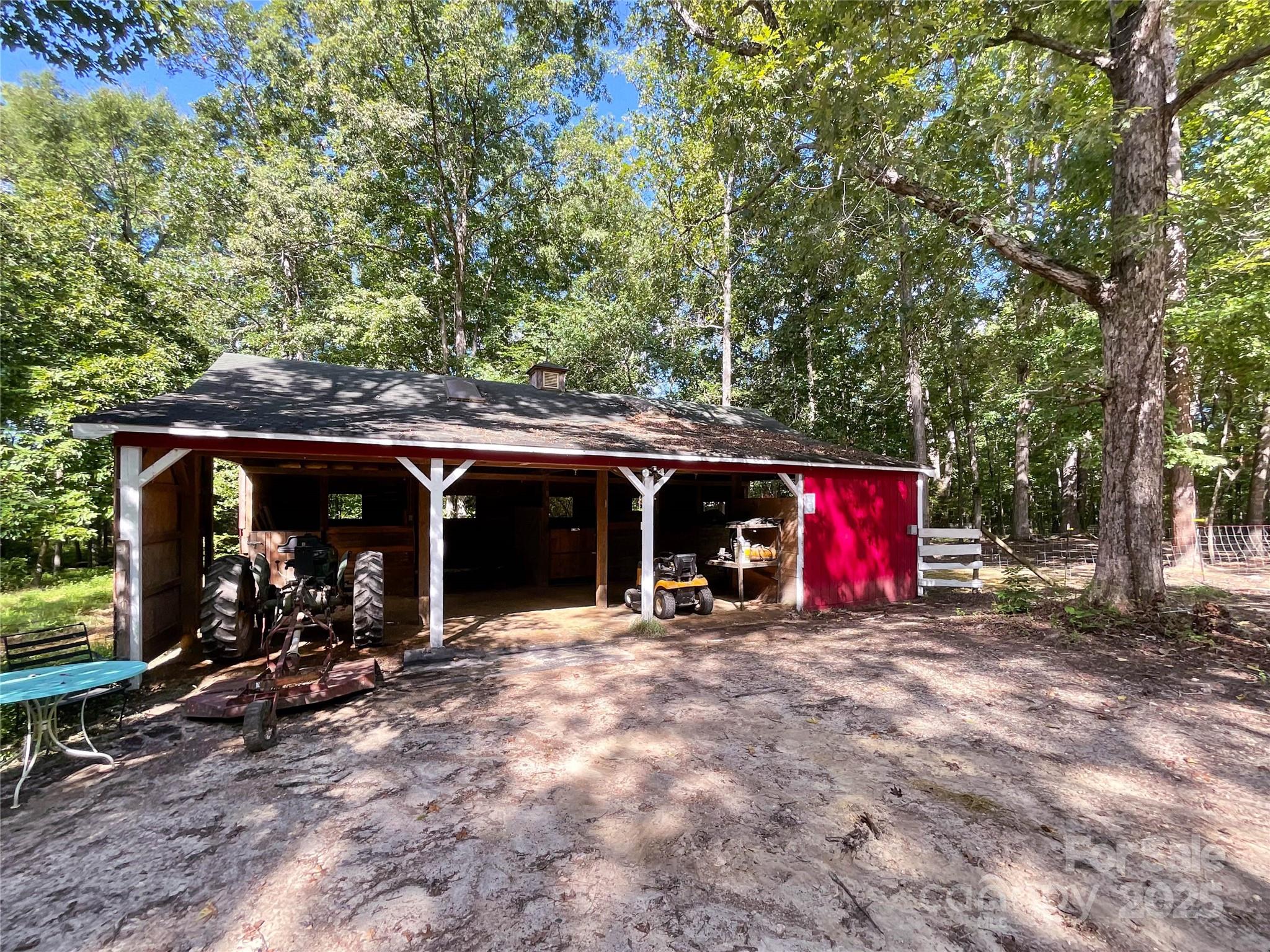 7204 Nesbit Road Waxhaw, NC 28173 - Photo 13 of 25 a view of a wooden house with large trees