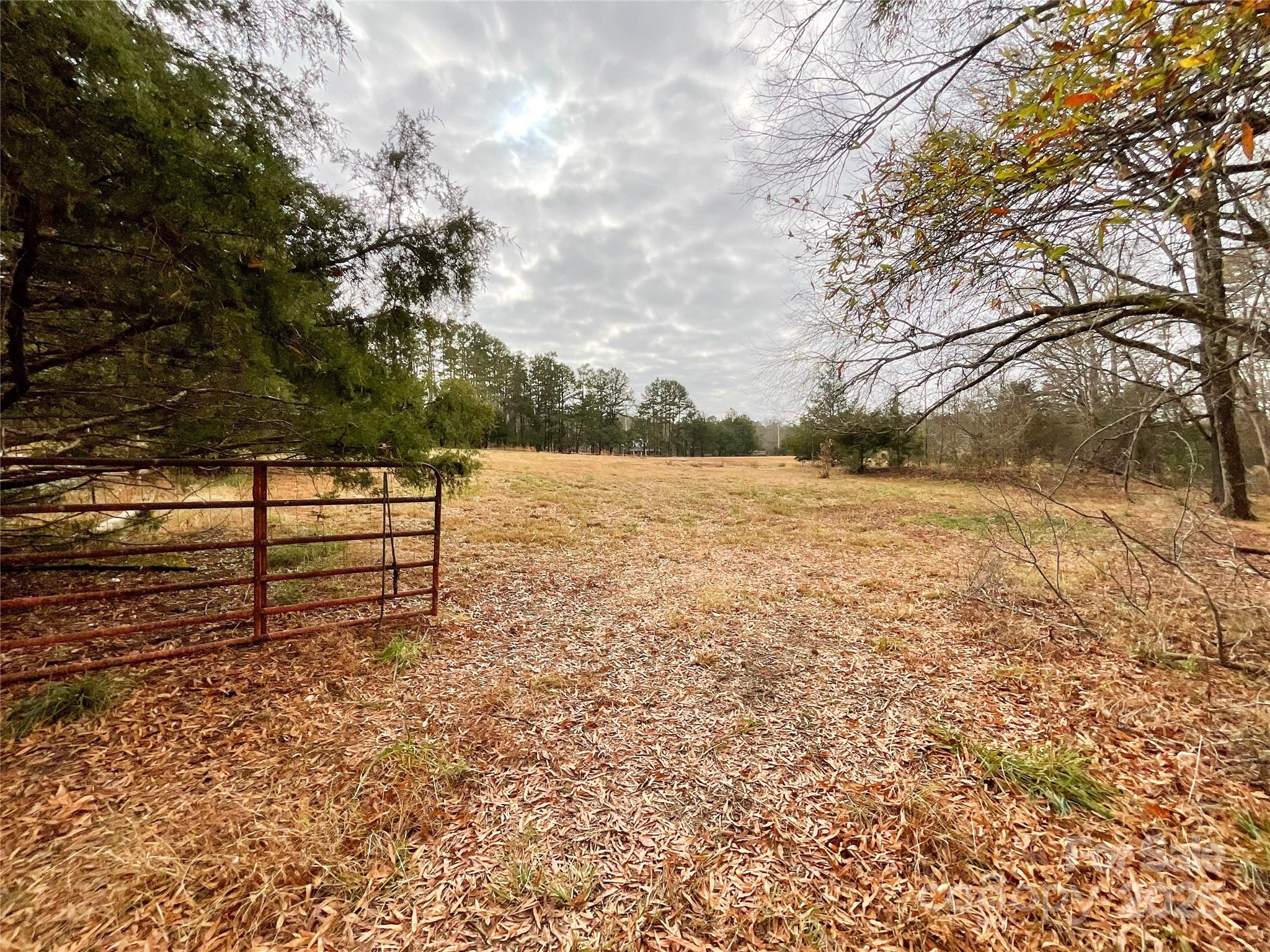 7204 Nesbit Road Waxhaw, NC 28173 - Photo 16 of 25 a view of a yard with wooden fence
