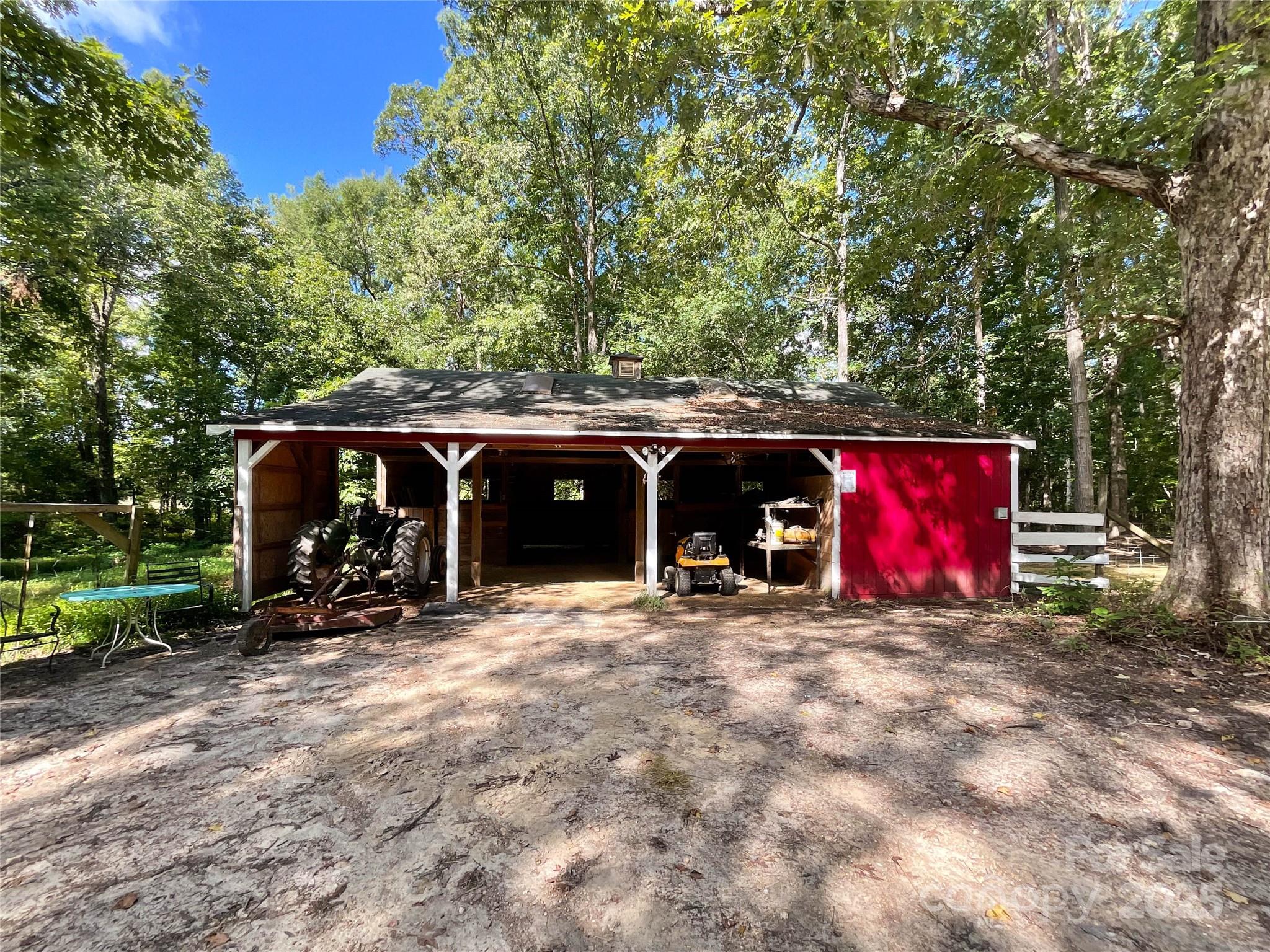 7204 Nesbit Road Waxhaw, NC 28173 - Photo 7 of 25 a view of a car parked in front of a house with red garage
