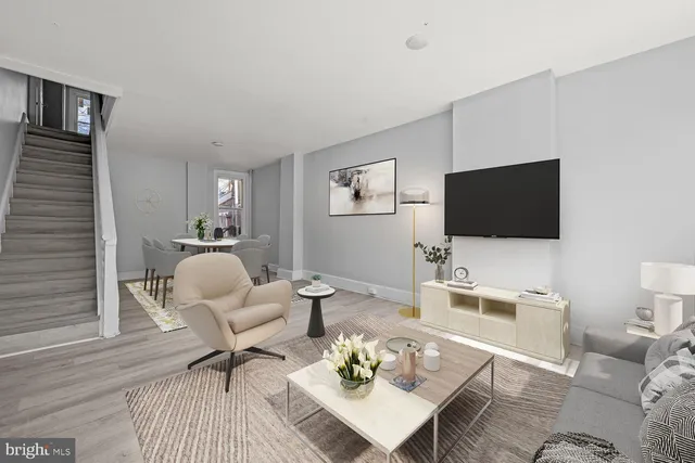 a living room with furniture and a flat screen tv