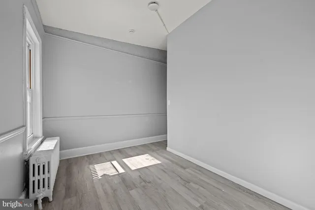 a view of a room with wooden floor