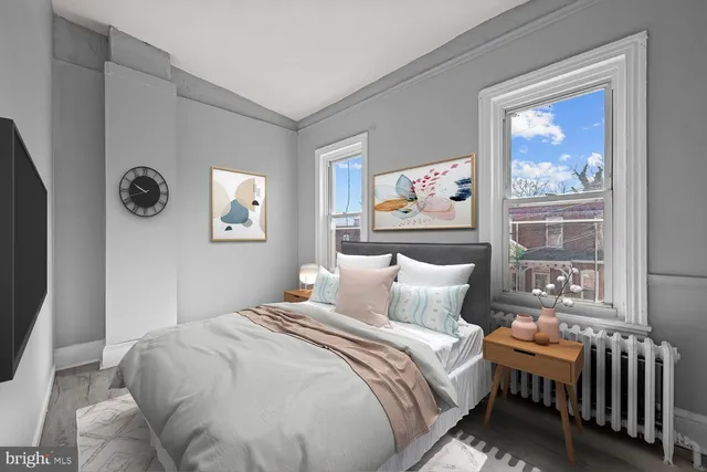 a bedroom with a bed and a painting on the wall