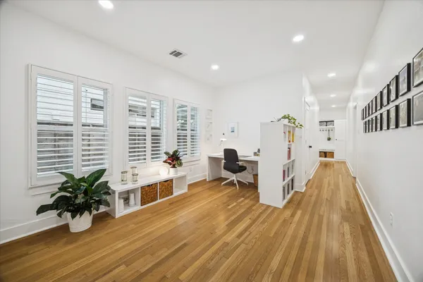 a view of a room with wooden floor and furniture