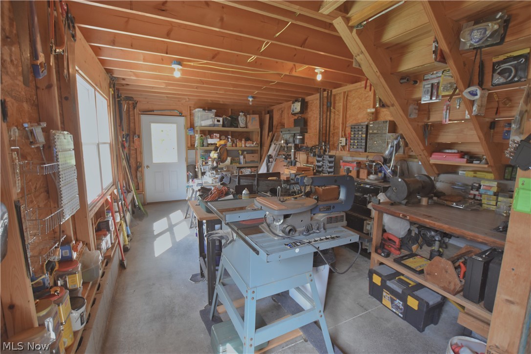 2873 Lodge Road Southwest Sherrodsville, OH 44675 - Photo 46 of 50 This workshop will be appreciated by the new owner and is accessed down a few steps from the garage. There is another area this same size directly above, perfect for storage of maybe a hobby room.