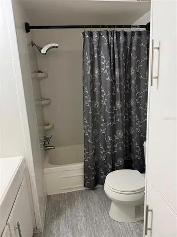 a bathroom with a toilet and a bathtub