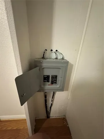 a view of a room with wooden floor and fan