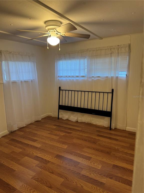 7289 Toucan Trail Spring Hill, FL 34606 - Photo 16 of 27 a view of a room with wooden floor and fan