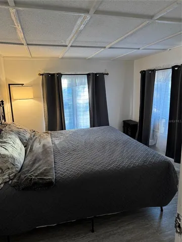 a bedroom with a bed and a mirror