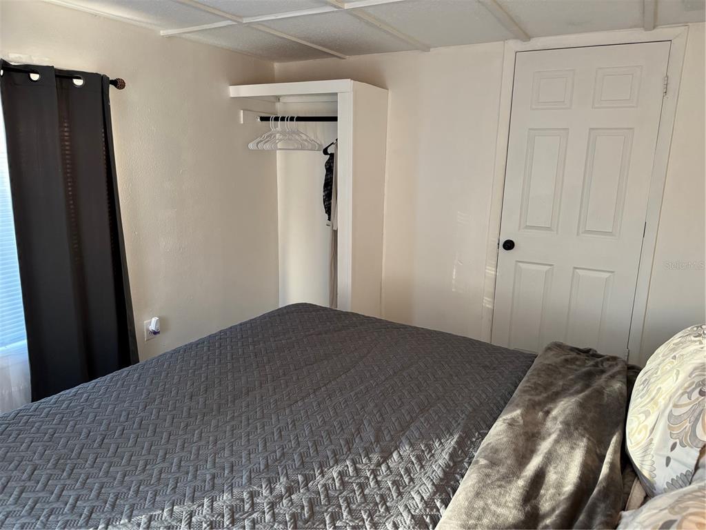 7289 Toucan Trail Spring Hill, FL 34606 - Photo 22 of 27 a bedroom with a bed and a mirror