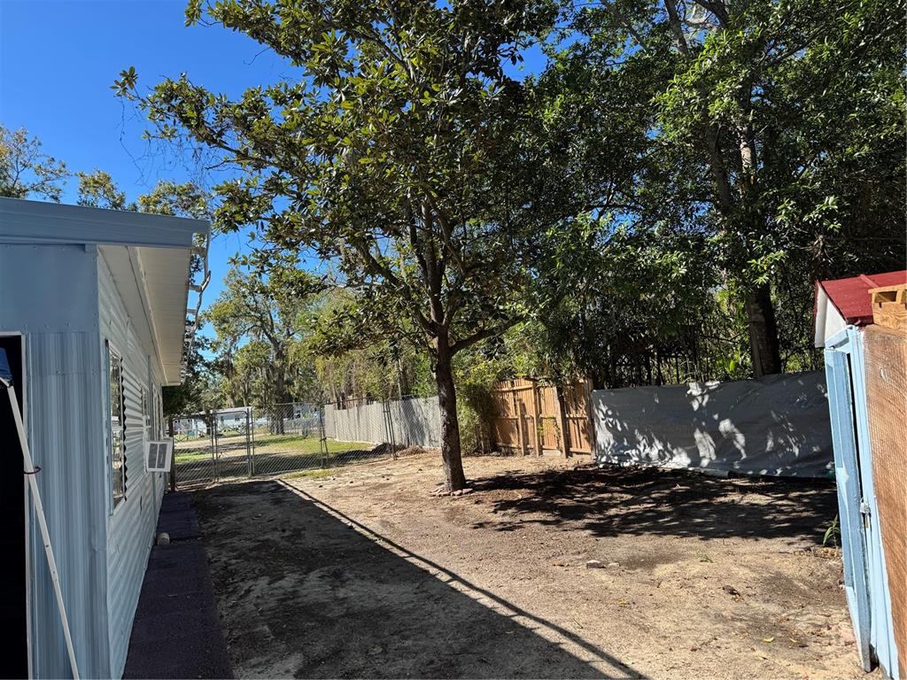 7289 Toucan Trail Spring Hill, FL 34606 - Photo 27 of 27 a view of a yard with wooden fence