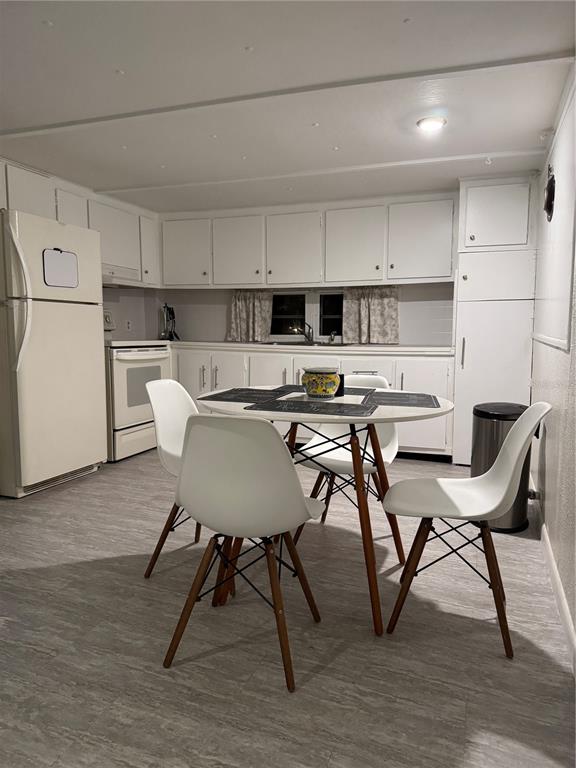 7289 Toucan Trail Spring Hill, FL 34606 - Photo 9 of 27 a kitchen with stainless steel appliances a table chairs and a refrigerator