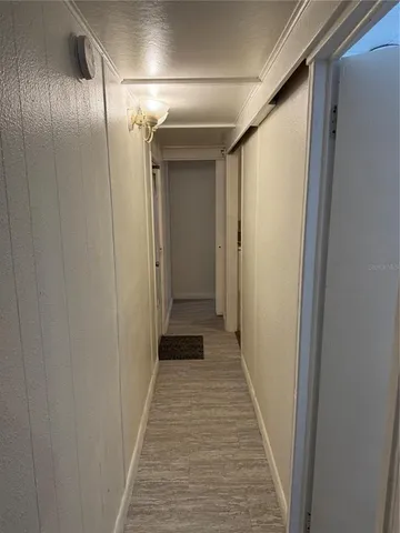 a view of hallway with wooden floor