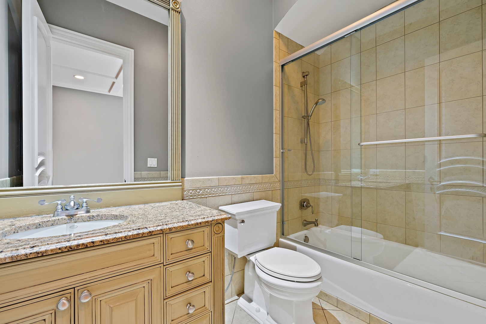 3151 Keystone Road Northbrook, IL 60062 - Photo 15 of 48 a bathroom with a granite countertop sink toilet mirror and shower