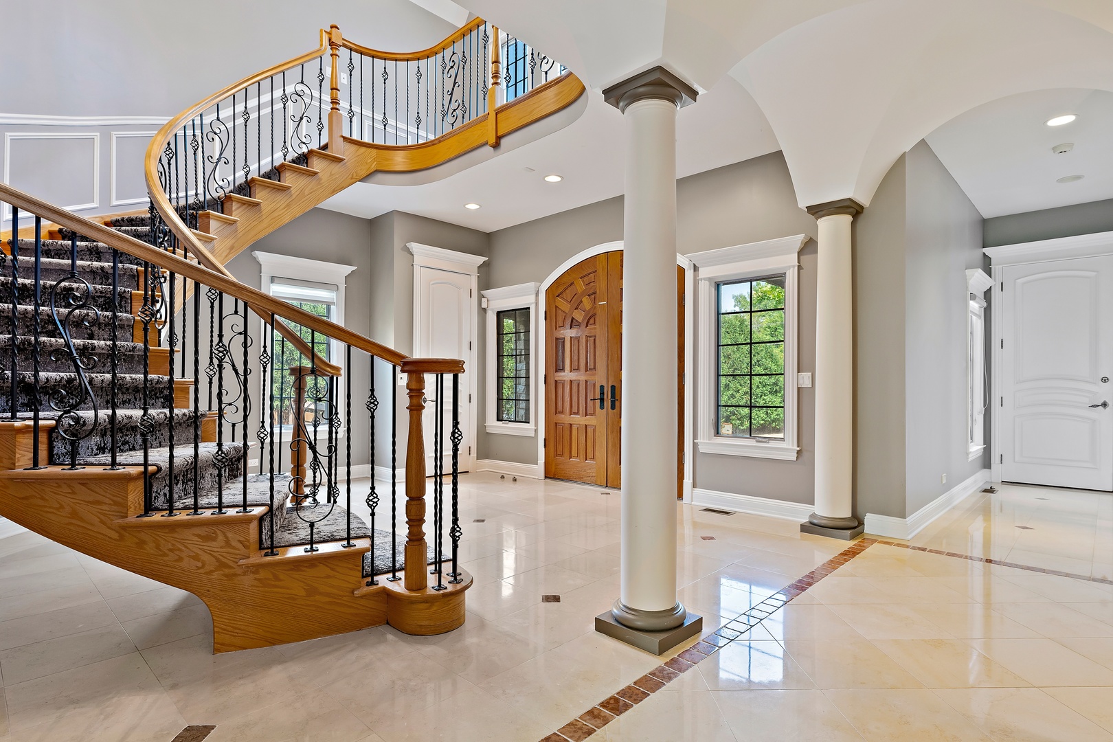 3151 Keystone Road Northbrook, IL 60062 - Photo 2 of 48 a view of staircase with lots of frames on wall and a chandelier