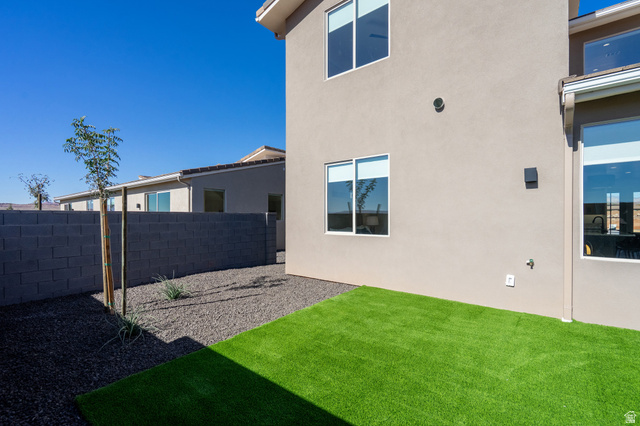 2972 West 570 North Hurricane, UT 84737 - Photo 86 of 104 Rear view of house featuring stucco siding and a fenced backyard