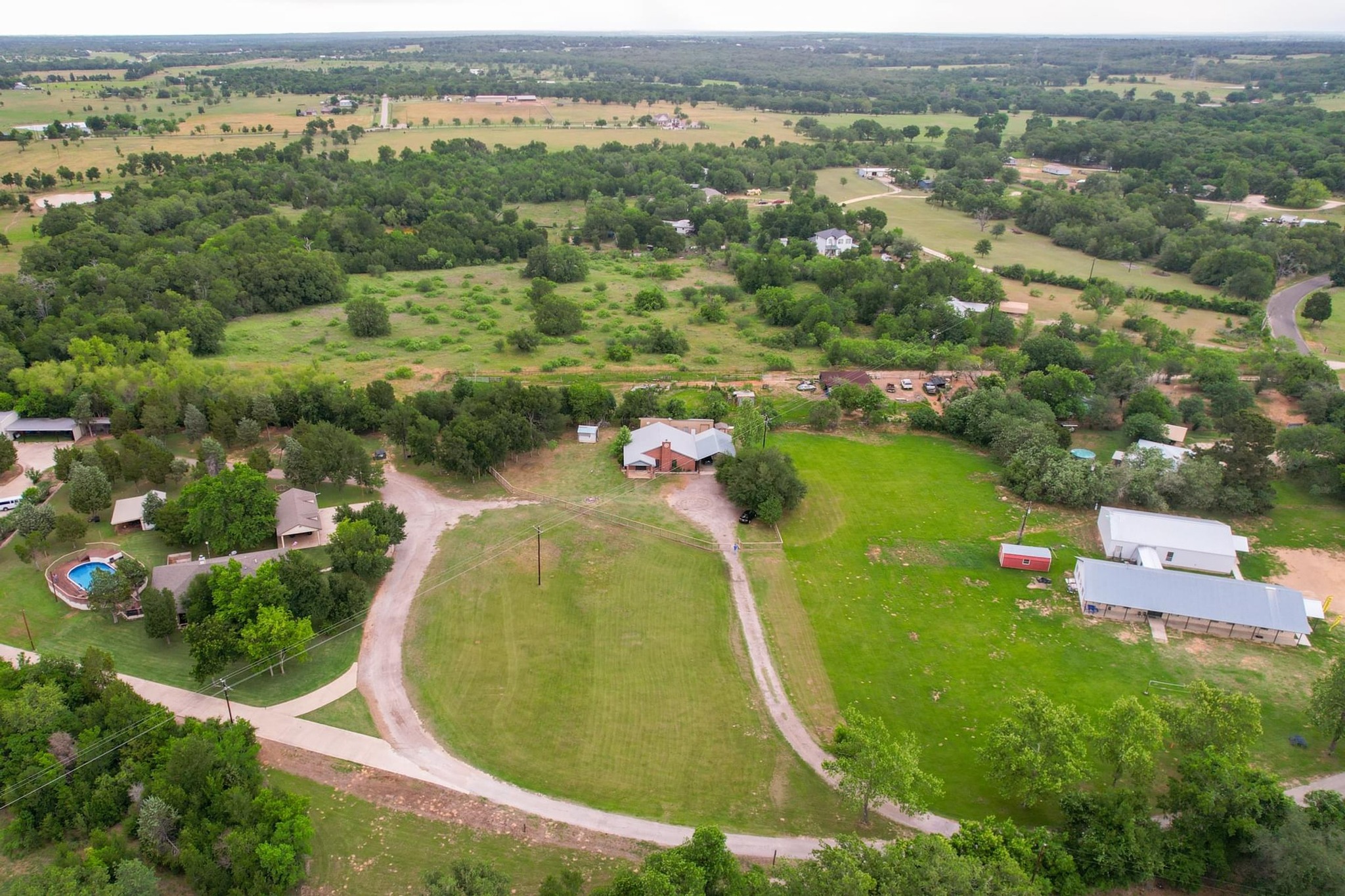 176 Old Lexington Road, Unit C Elgin, TX 78621 - Photo 27 of 31 an aerial view of residential houses with outdoor space and swimming pool