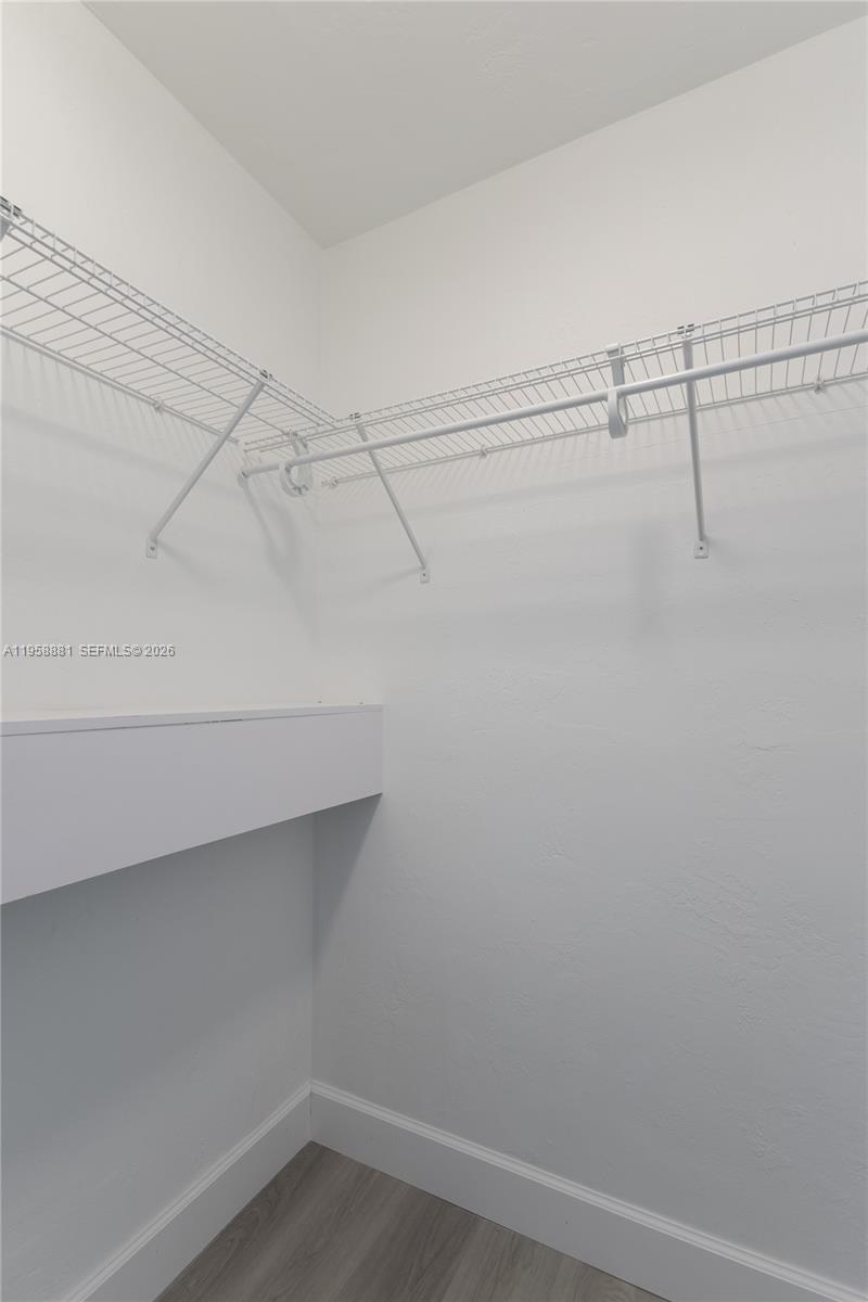 5301 Southwest 77th Court, Unit 201G Miami, FL 33155 - Photo 12 of 17 a view of a room with racks on the wall