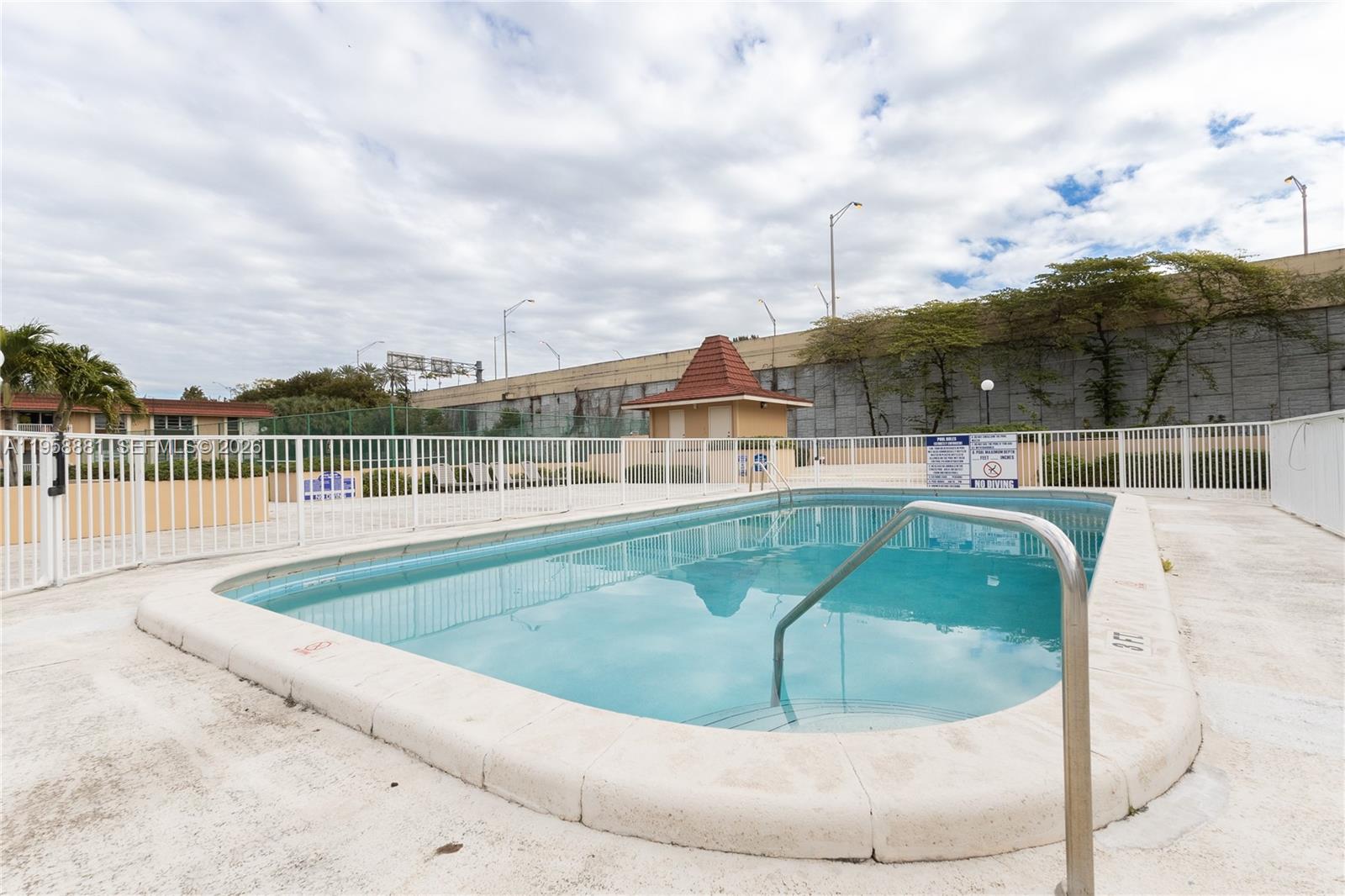 5301 Southwest 77th Court, Unit 201G Miami, FL 33155 - Photo 17 of 17 a view of a swimming pool with a garden