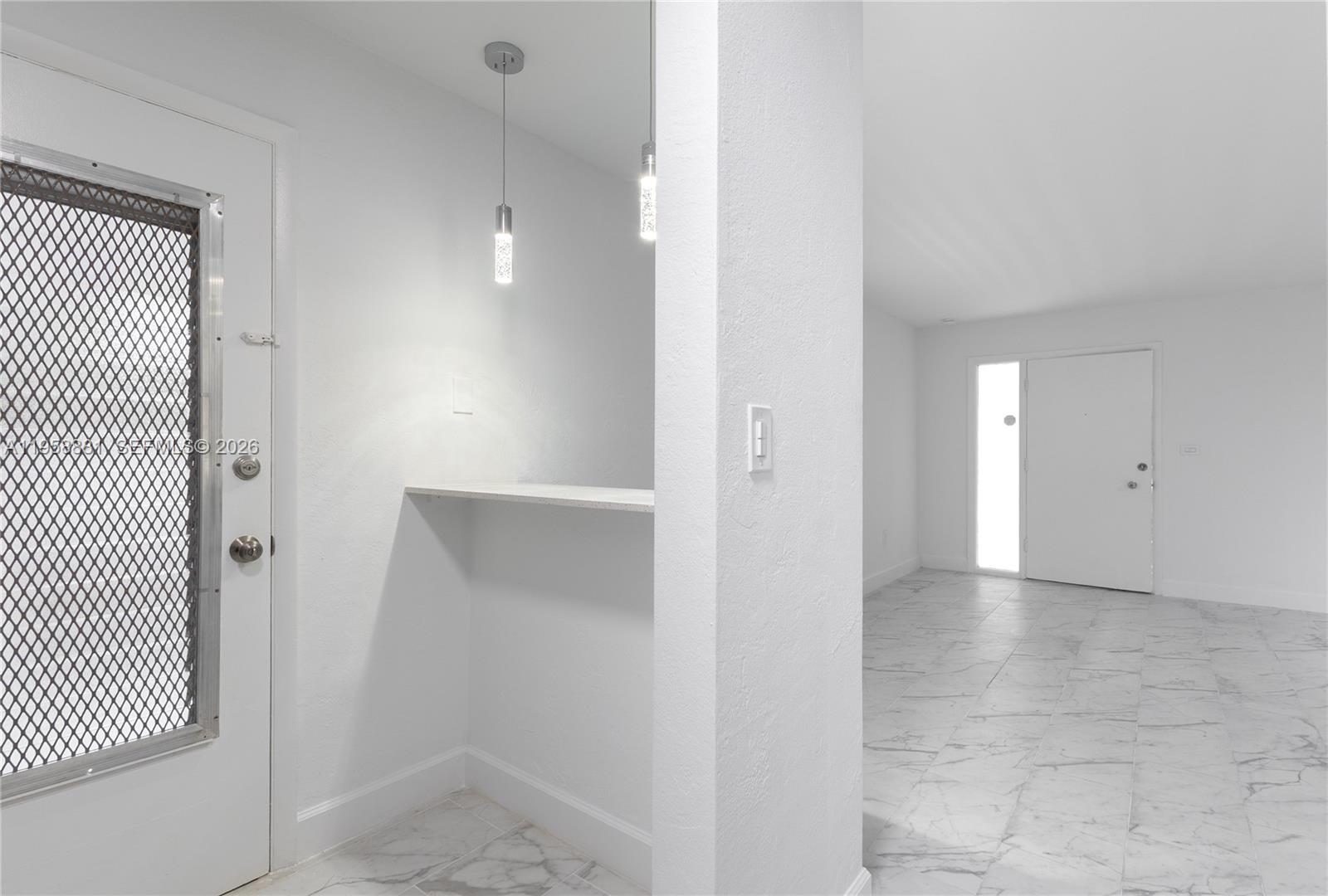 5301 Southwest 77th Court, Unit 201G Miami, FL 33155 - Photo 7 of 17 an empty room with wooden floor and windows