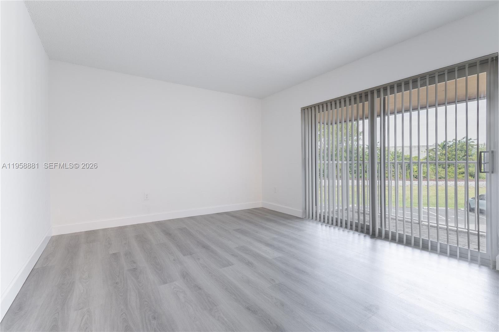 5301 Southwest 77th Court, Unit 201G Miami, FL 33155 - Photo 9 of 17 a view of a room with wooden floor and windows