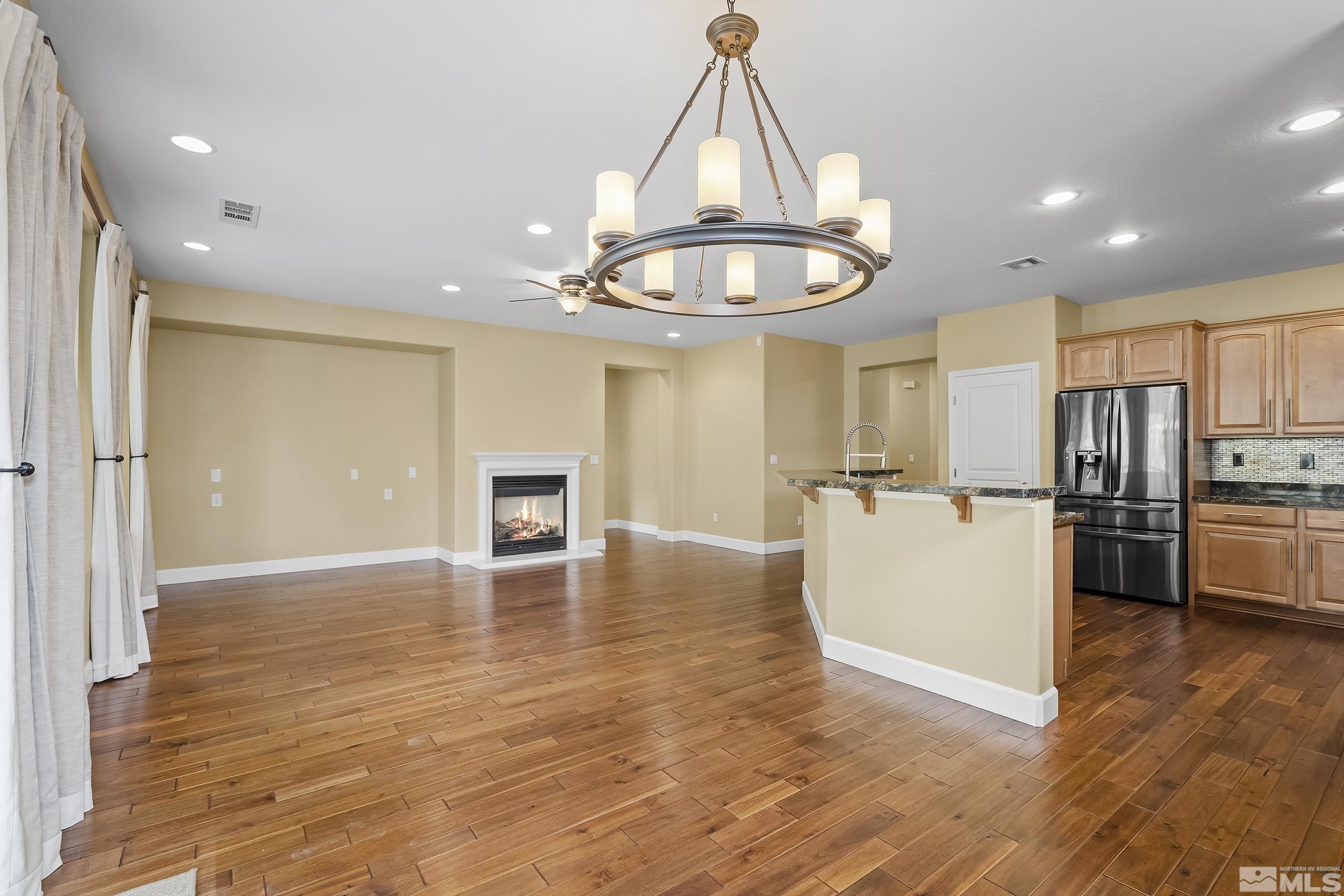 1745 Trail Creek Way Reno, NV 89523 - Photo 12 of 28 a view of a kitchen and a refrigerator wooden floor kitchen view