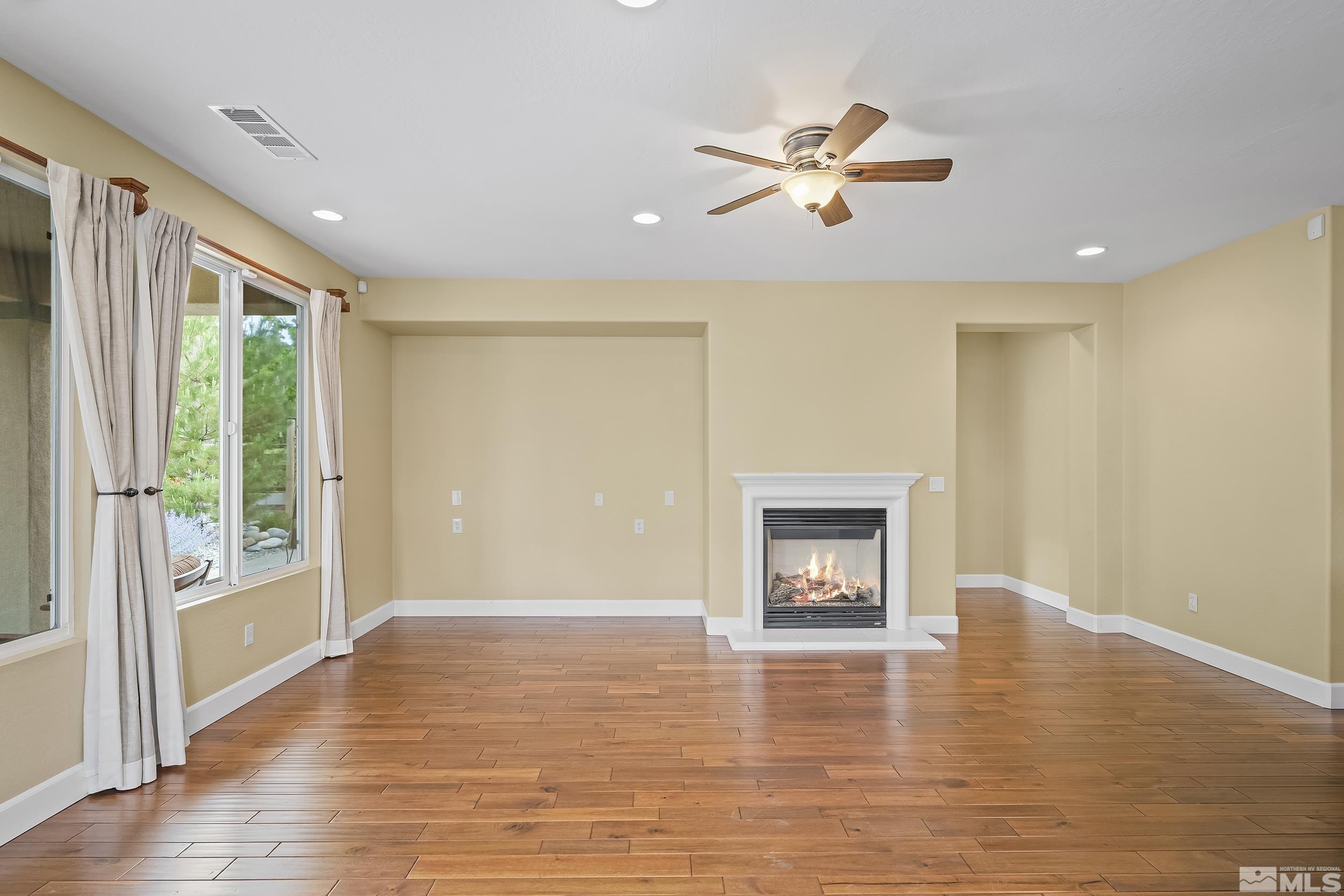 1745 Trail Creek Way Reno, NV 89523 - Photo 14 of 28 a view of an empty room with wooden floor and a window