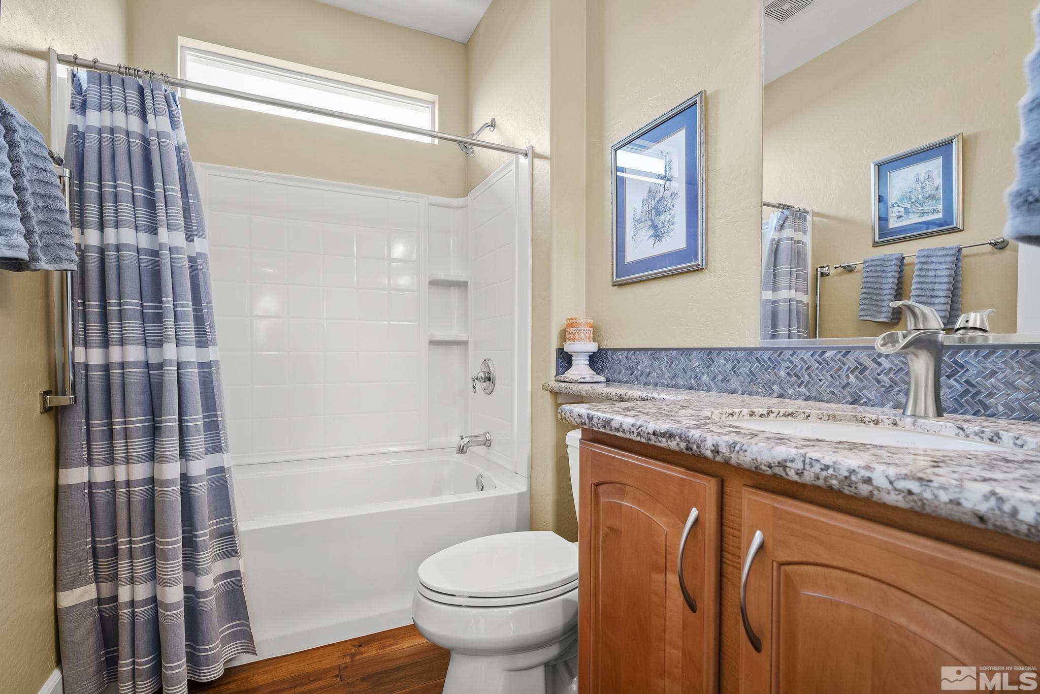1745 Trail Creek Way Reno, NV 89523 - Photo 21 of 28 a bathroom with a granite countertop sink toilet and shower