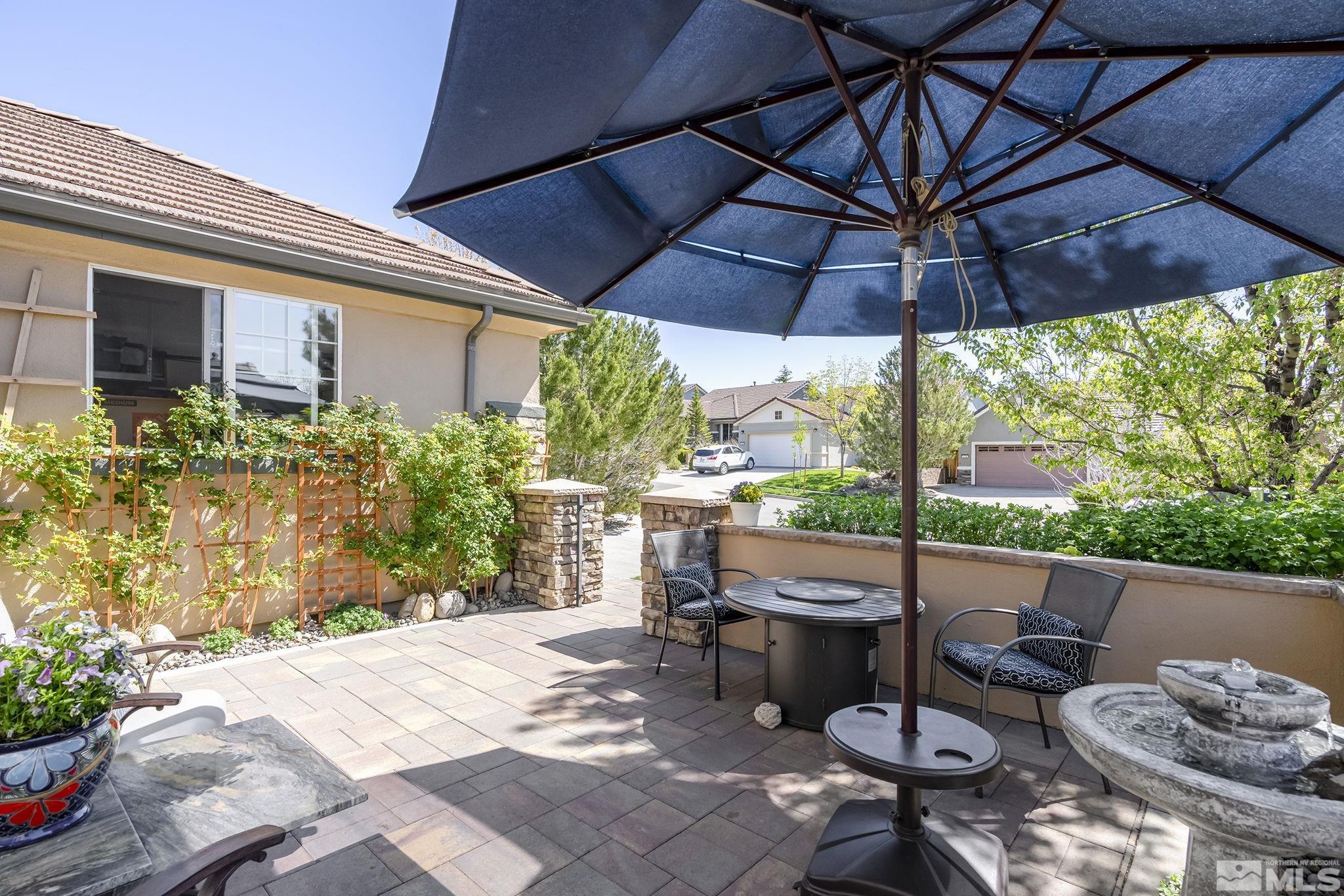 1745 Trail Creek Way Reno, NV 89523 - Photo 25 of 28 a view of a patio with table and chairs under an umbrella