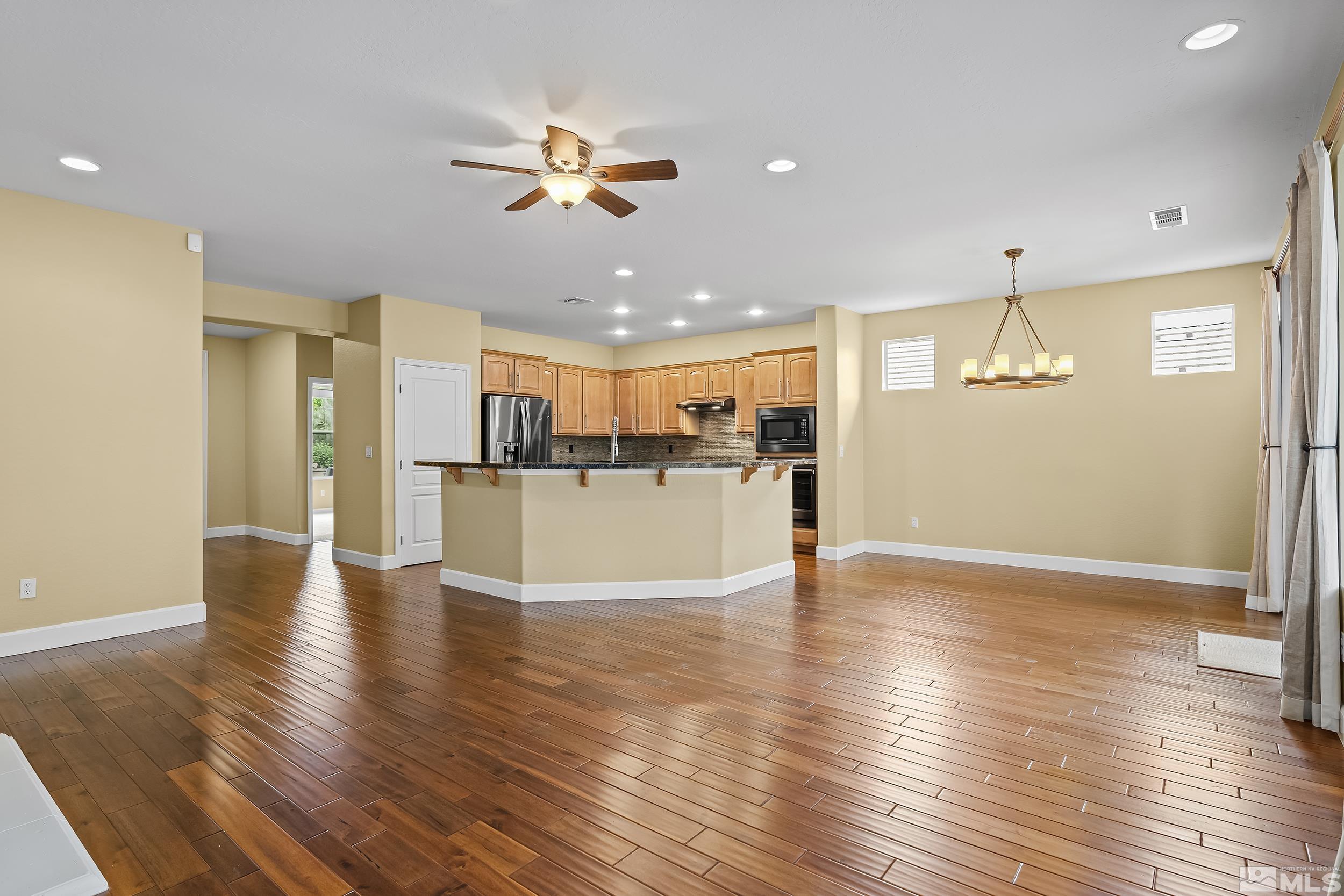 1745 Trail Creek Way Reno, NV 89523 - Photo 4 of 28 a view of a kitchen with a refrigerator and wooden floor