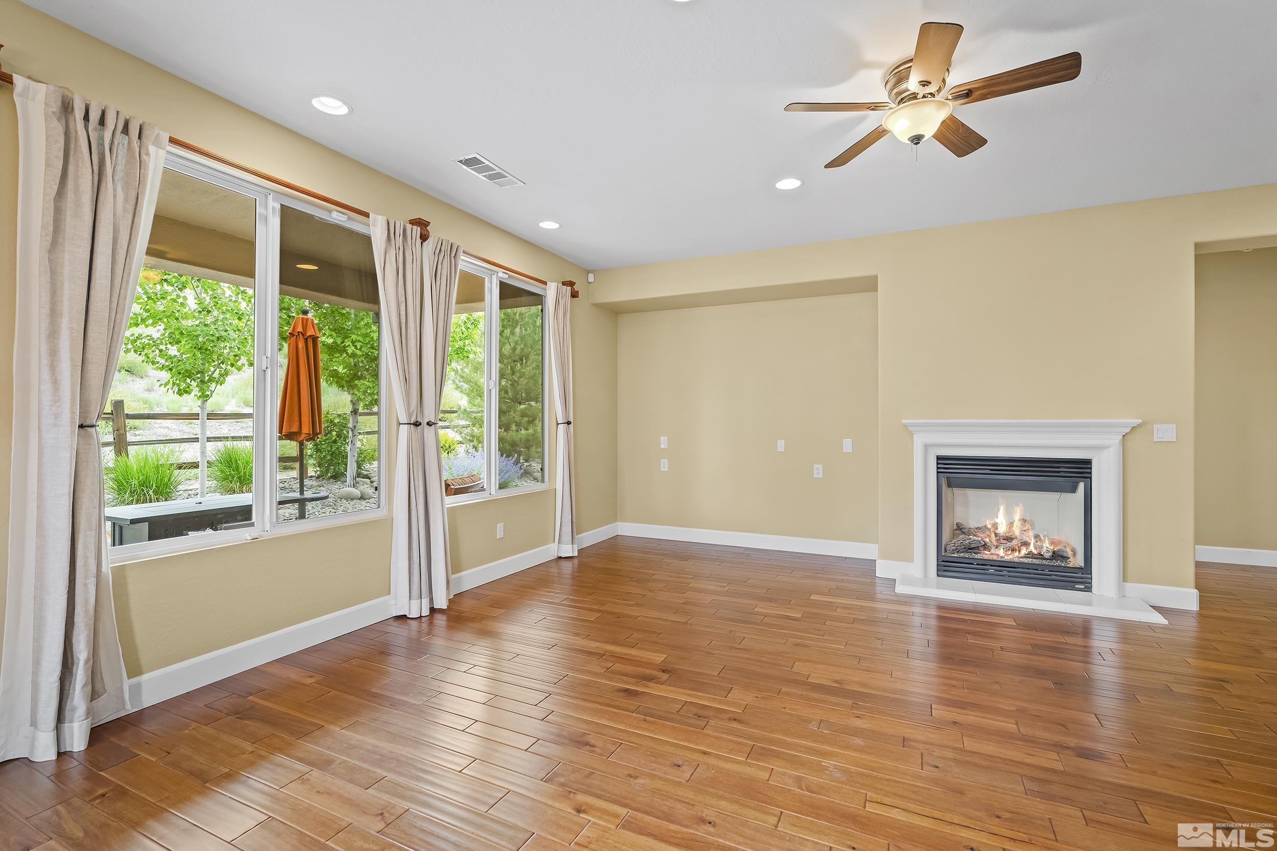1745 Trail Creek Way Reno, NV 89523 - Photo 7 of 28 a view of an empty room with a window and wooden floor