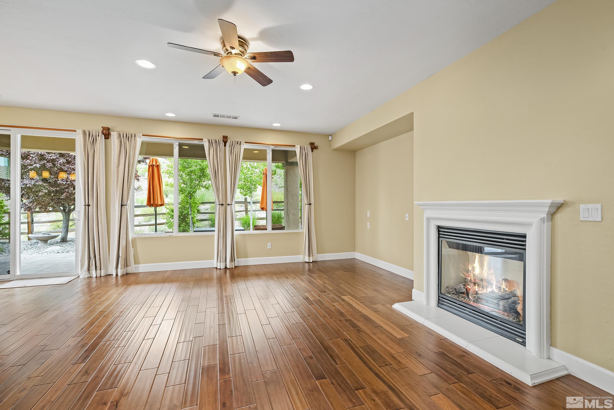 1745 Trail Creek Way Reno, NV 89523 - Photo 8 of 28 a view of an empty room with a window and wooden floor