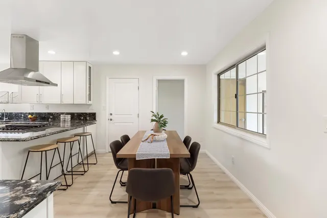 a view of a dining room with furniture and wooden floor