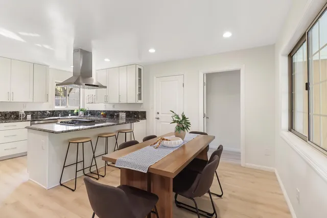 a kitchen with stainless steel appliances granite countertop a stove a sink and a refrigerator