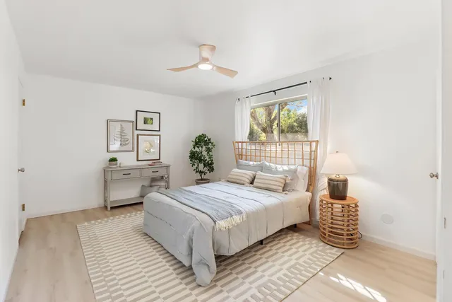 a bathroom with a bathtub shower sink vanity and toilet