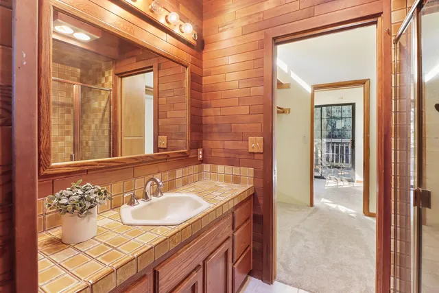 a view of a hallway with wooden floor and dining room