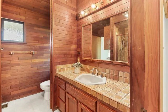 a balcony with wooden floor and fence