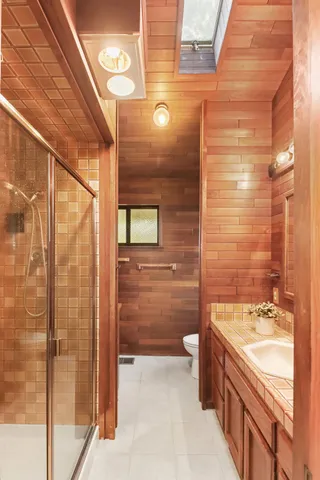 a view of an empty room with wooden floor and a large window