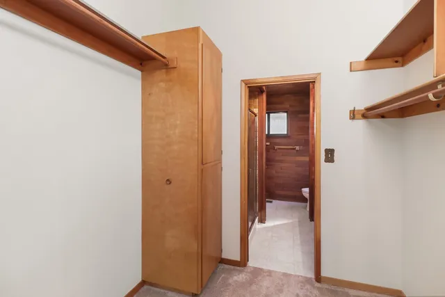 a view of an empty room with windows and balcony