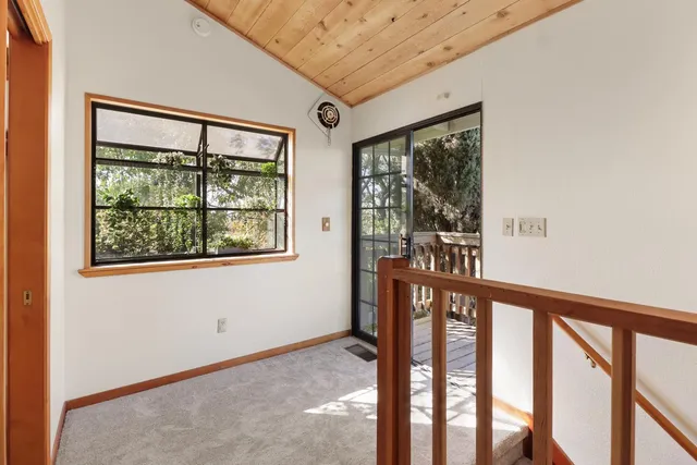 a view of an empty room with glass door