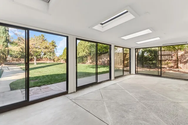 a view of a yard with large trees